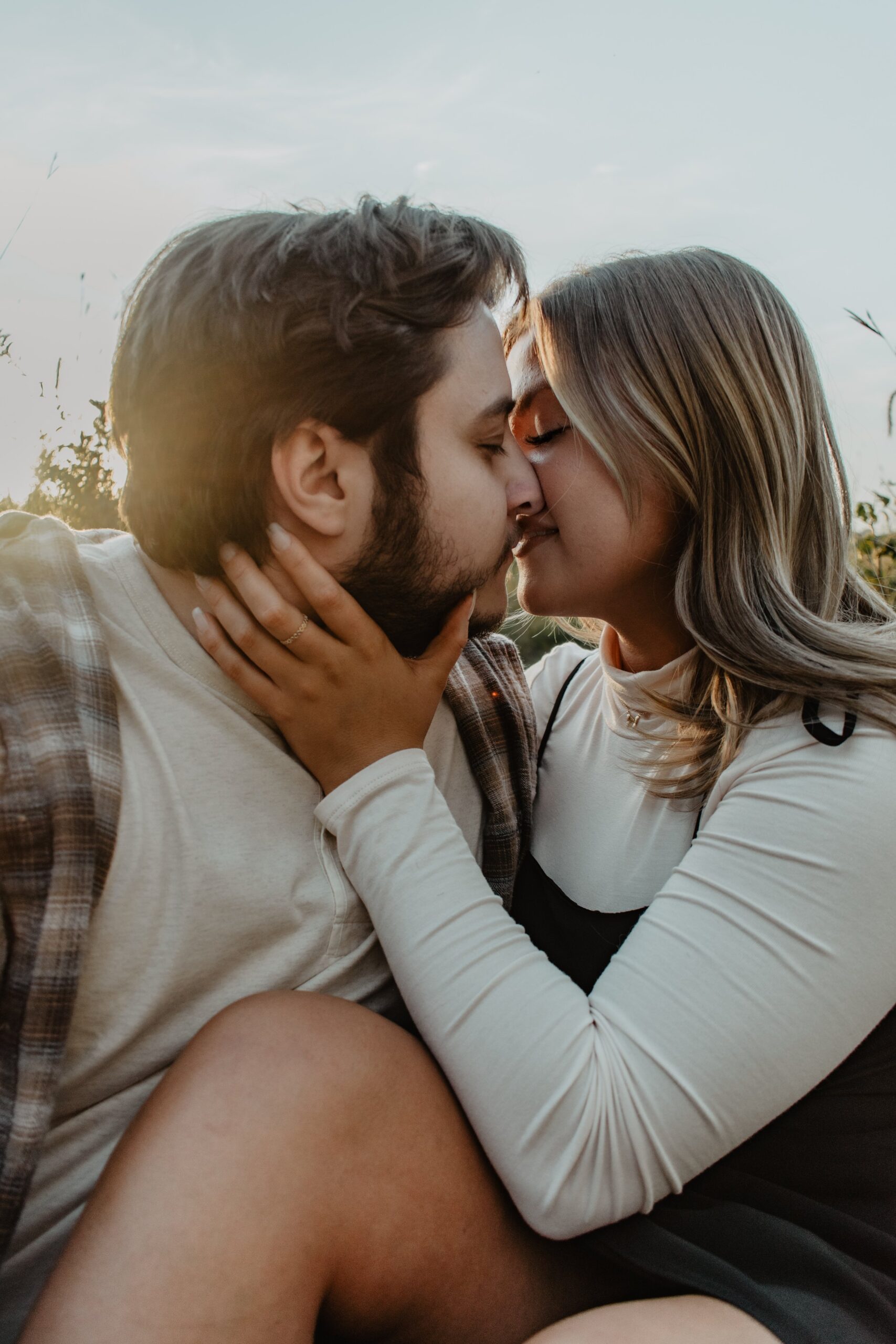 Couple kissing in a field